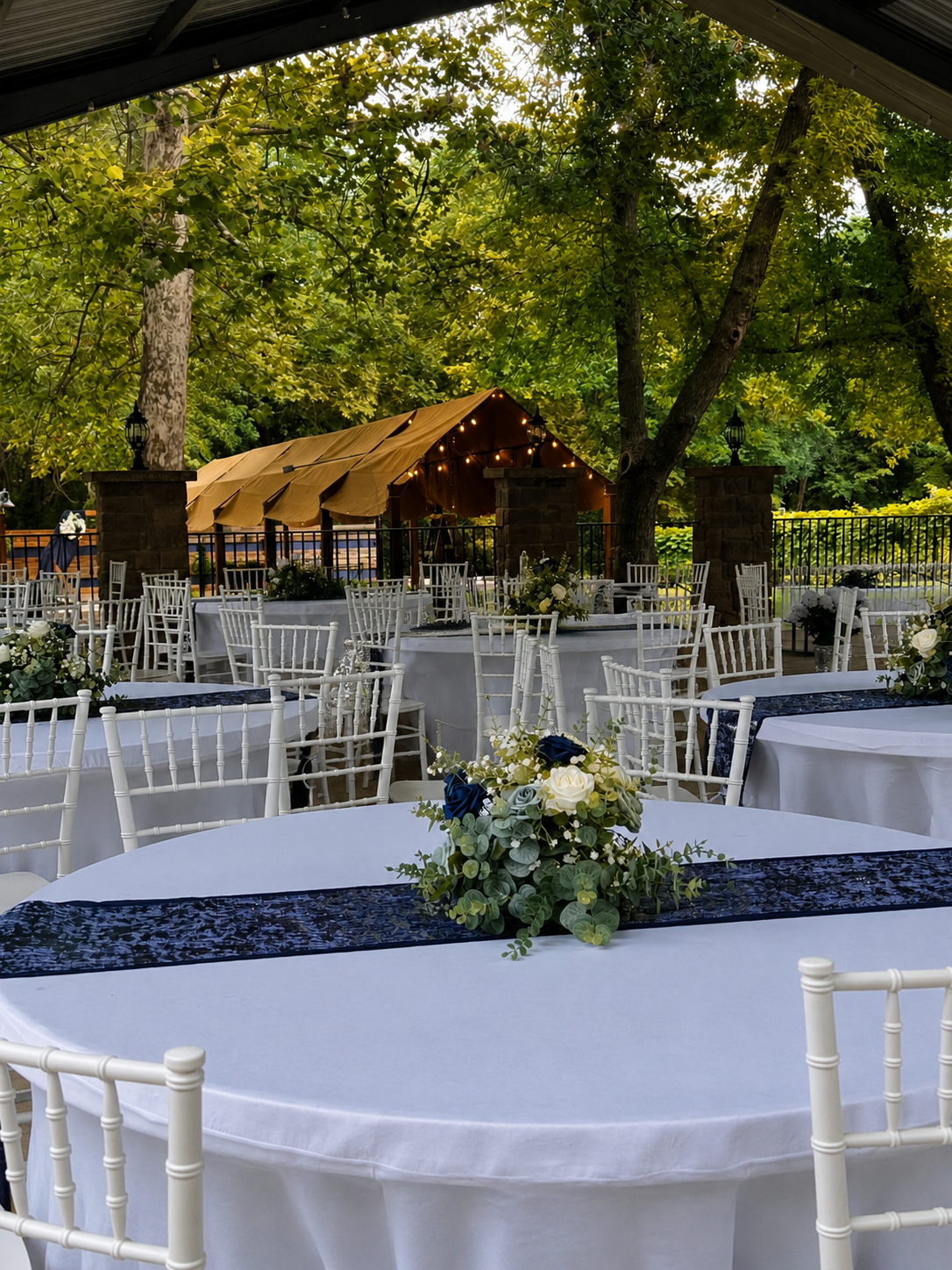 Pavilion wedding table setup on wooded grounds at Sugar Hollow Crossing in Sugar Creek Missouri