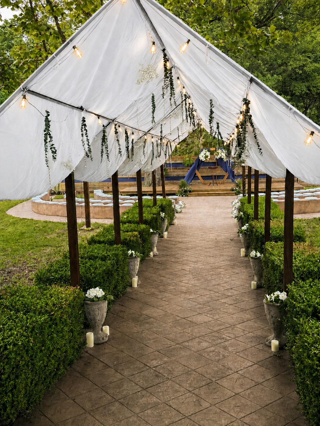 White canvas wedding arch along the pathway to the amphitheater at Sugar Hollow Crossing